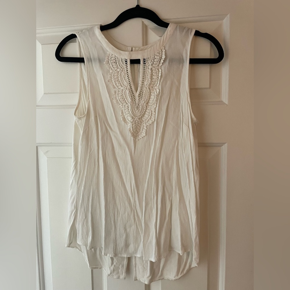 White sleeveless blouse with crochet detail